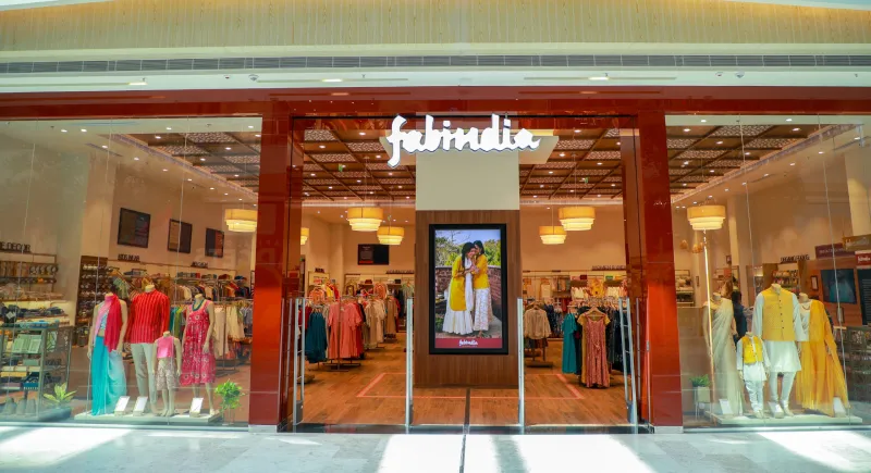 A well-lit entrance of an fashion retail outlet named FabIndia