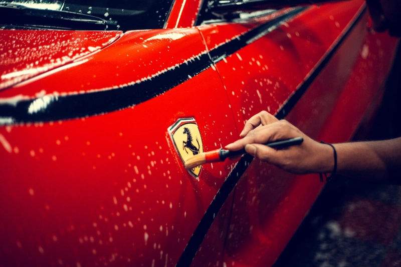 a red Ferrari being detailed