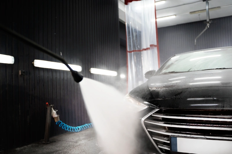 a black car undergoing an automatic car wash