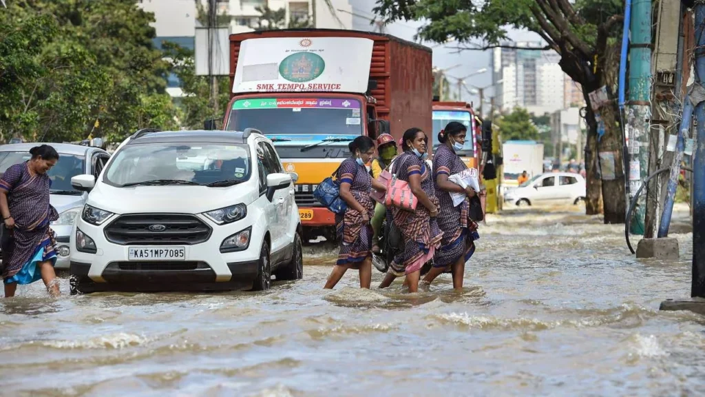 People crossing road filled with water