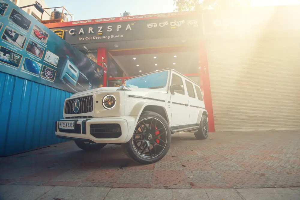 A white Mercedes G Wagon in front of CarzSpa studio