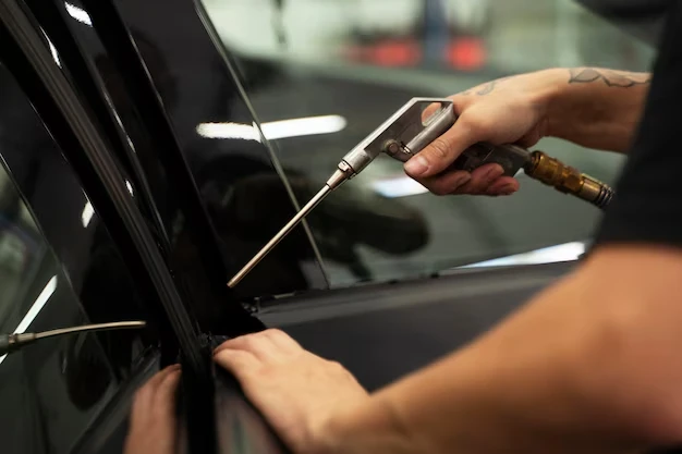 A worker cleaning car