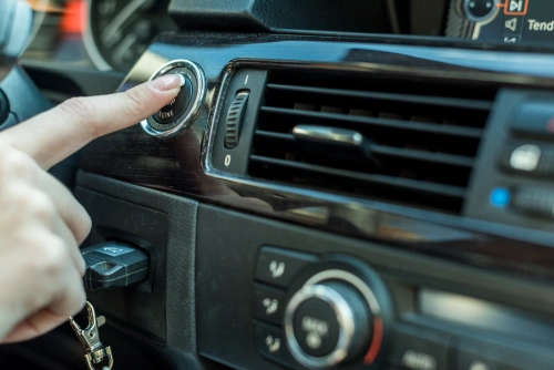 a woman switches on the AC in her car