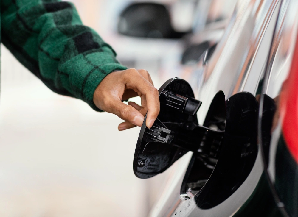 a man checks the fuel tank of his car