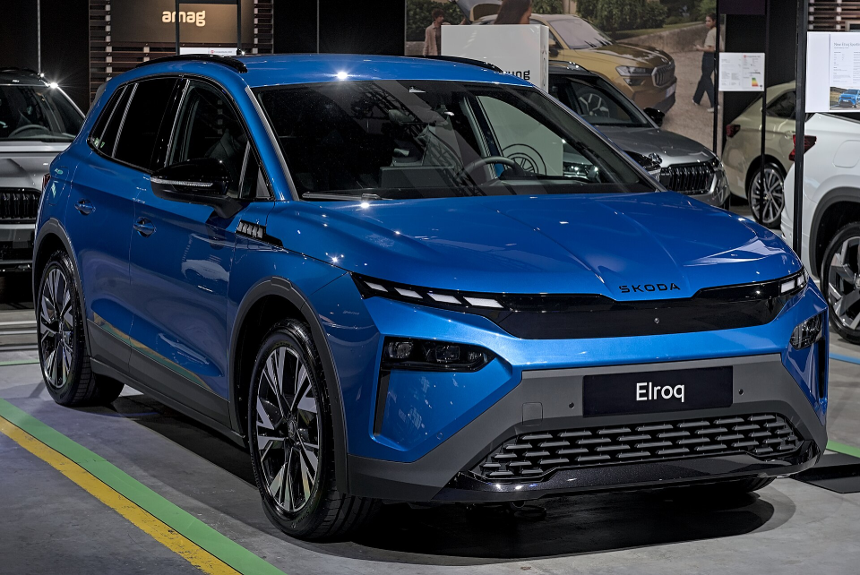 A bright blue Skoda Elroq showcased at a car expo