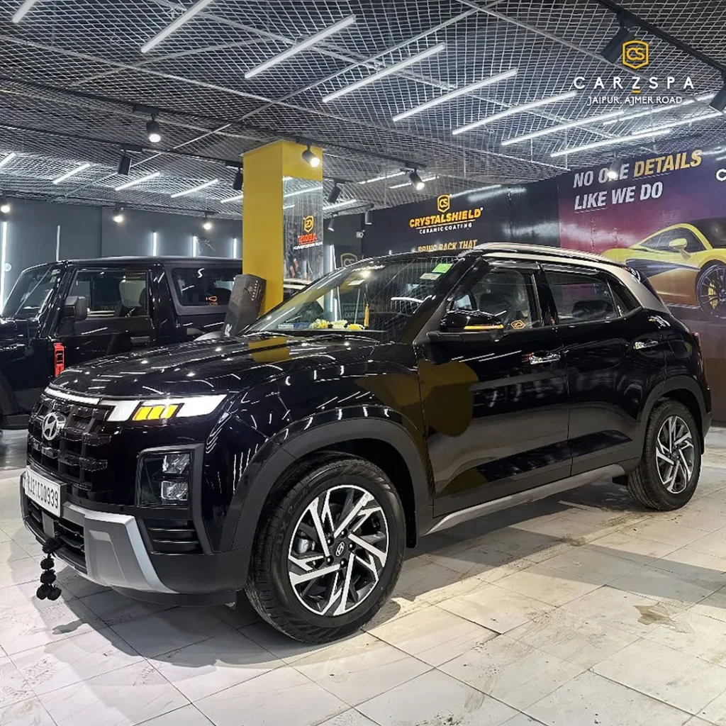 A shiny black Hyundai Creta parked inside a CarzSpa Detailing Studio in Rajasthan