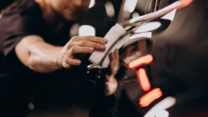 close-up view of a car being applied with ceramic coating by a worker