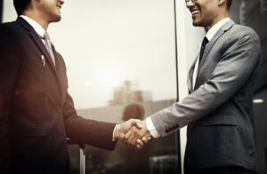 Two businessmen shaking hands, symbolising a franchise deal