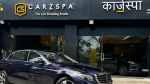 A black coloured Mercedes sedan parked outside a CarzSpa Detailing Studio in Navi Mumbai